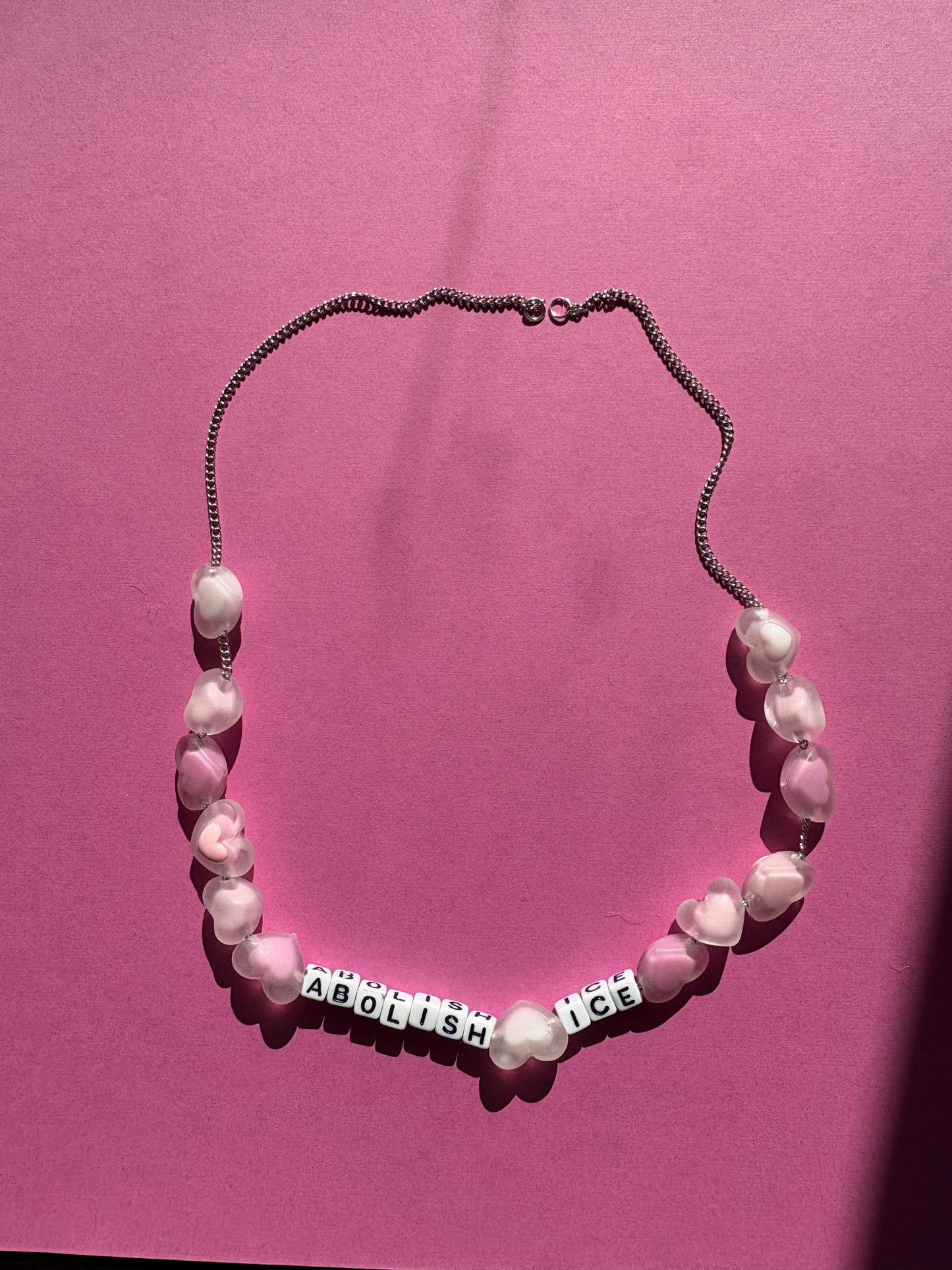 Abolish ICE, pink heart necklace