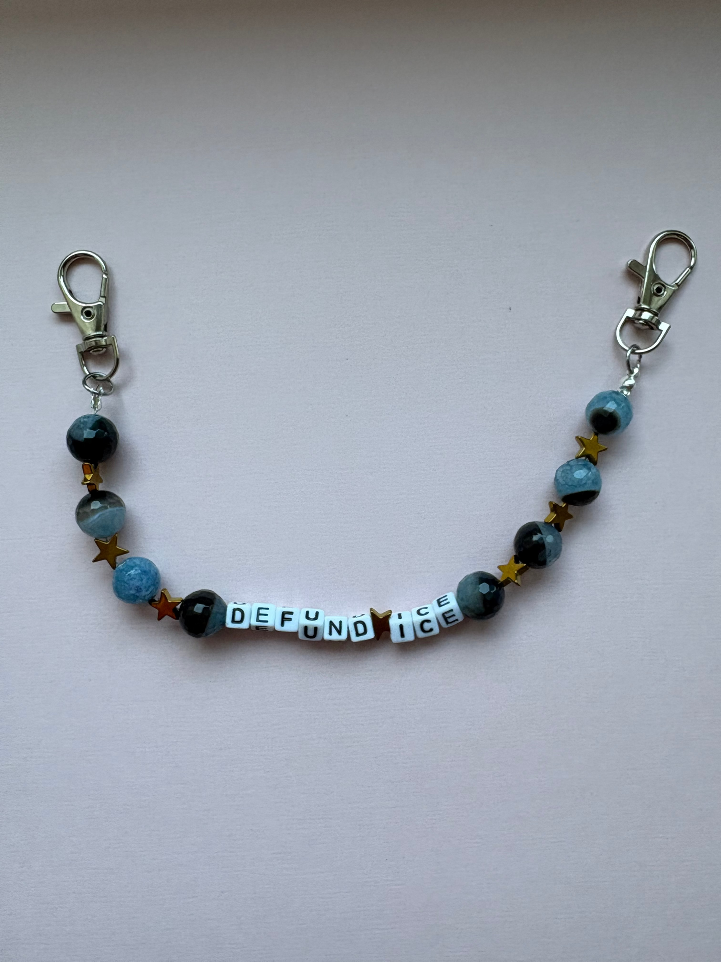 DEFUND ICE globe and gold star bag charm