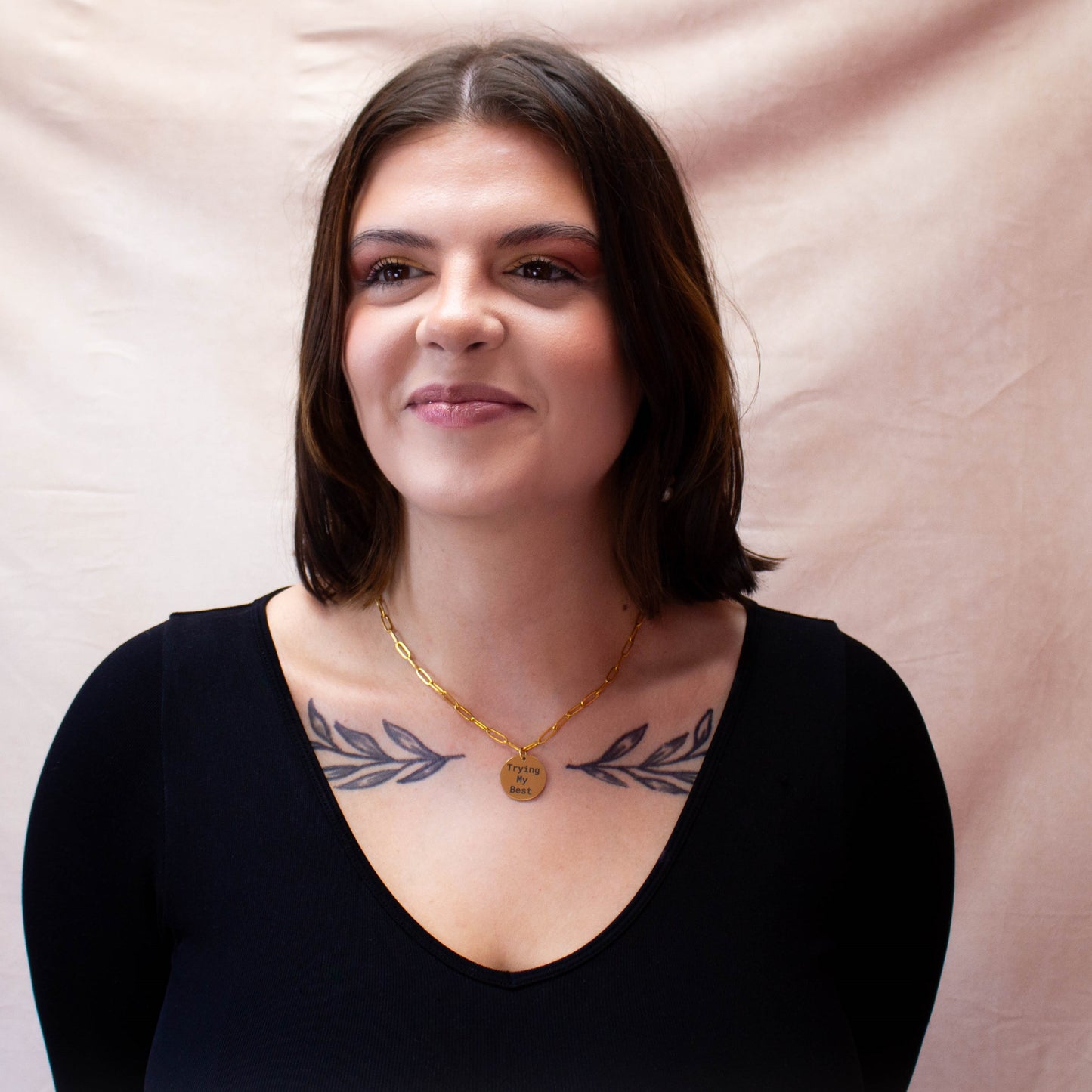full model portrait displaying "Trying my best" engraved charm necklace