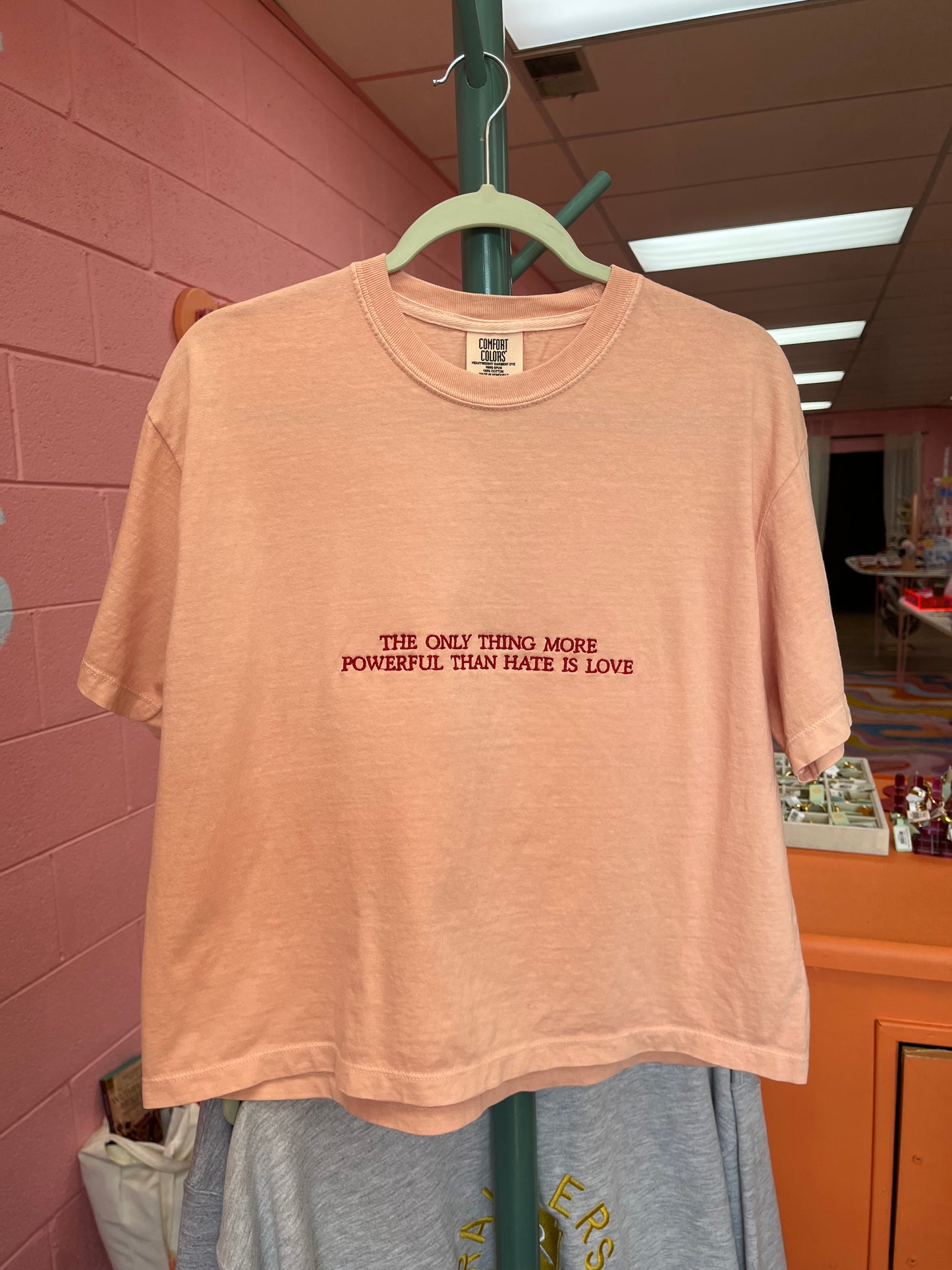 “The Only Thing More Powerful Than Love is Hate” Embroidered Shirt
