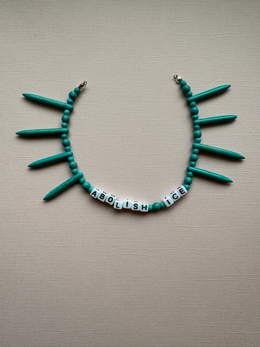 Abolish ICE pointed turquoise bag charm