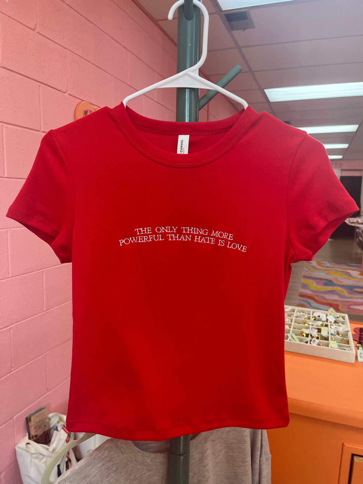“The Only Thing More Powerful Than Love is Hate” Embroidered Shirt