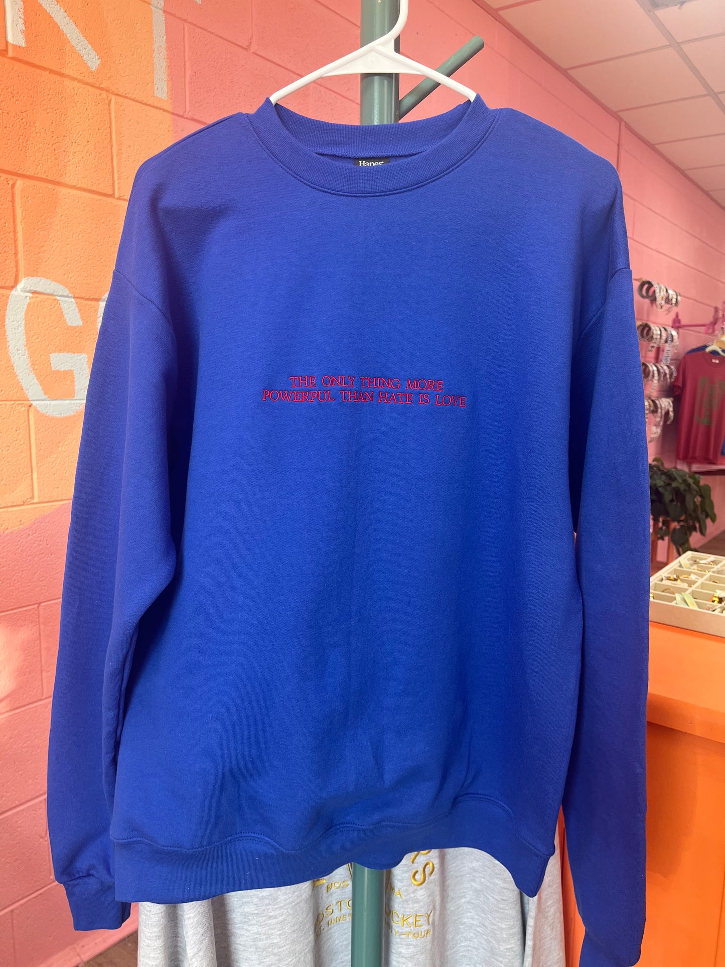 “The Only Thing More Powerful Than Love is Hate” Embroidered Shirt