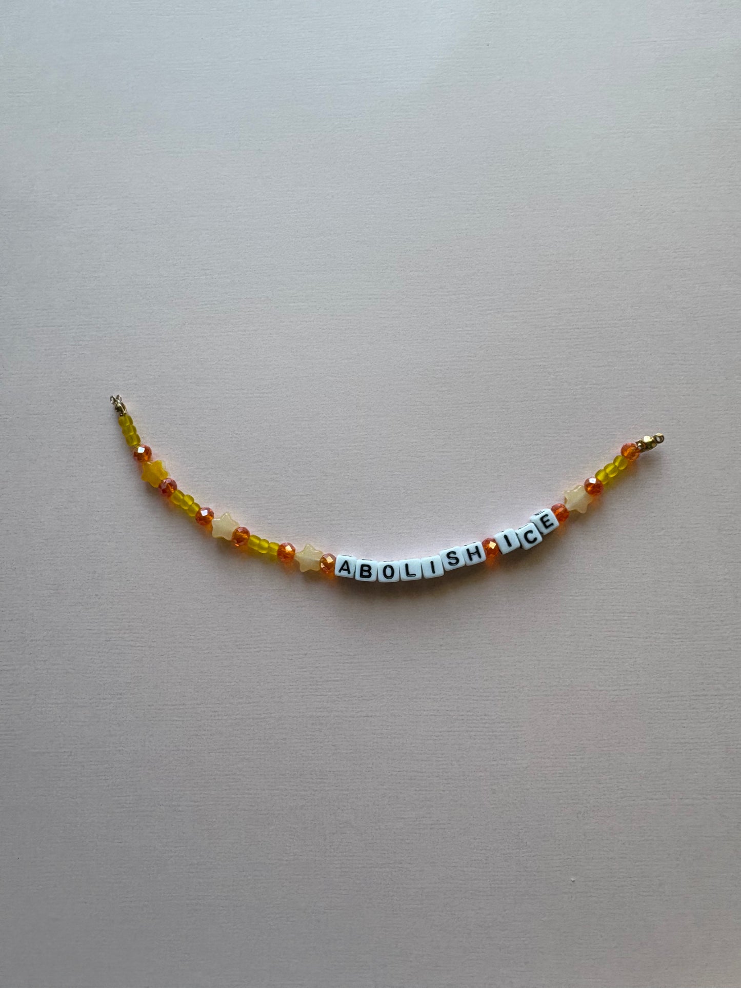 ABOLISH ICE orange and yellow phone charm or bracelet