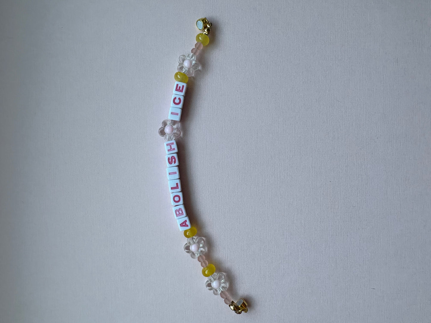 ABOLISH ICE pink and yellow bracelet