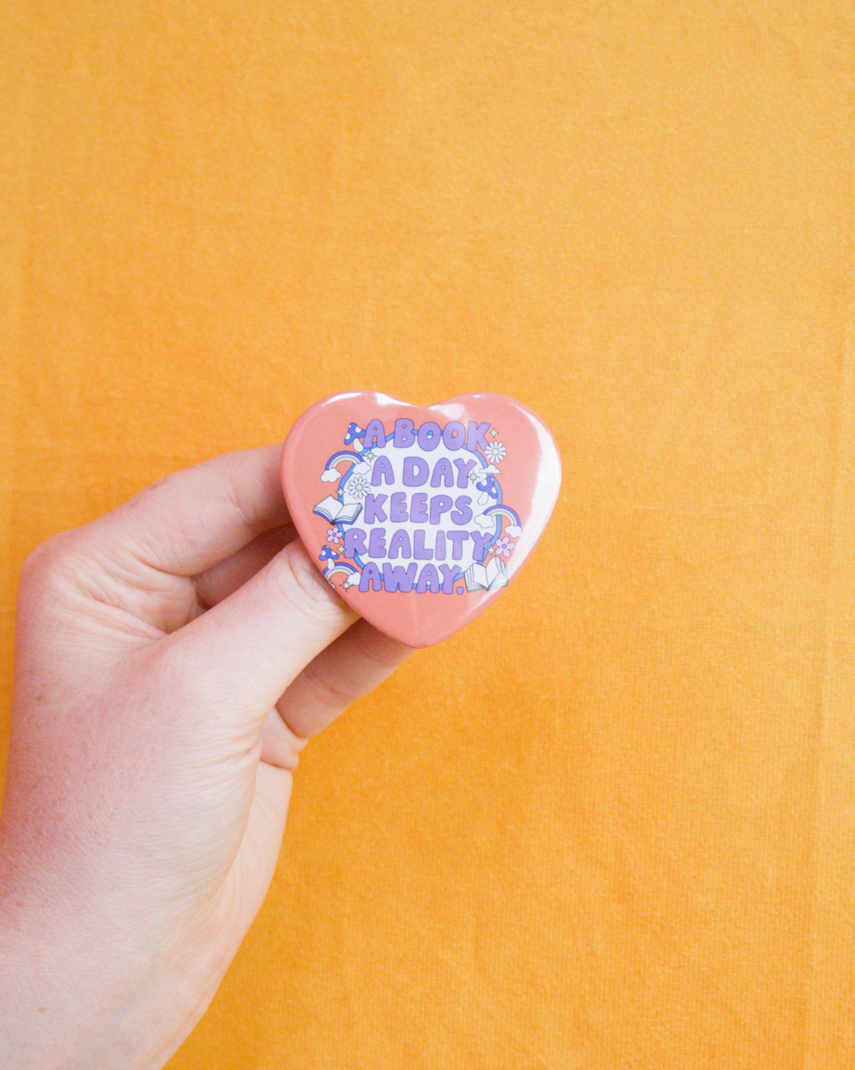 "A book a day keeps reality away" Heart shaped pin