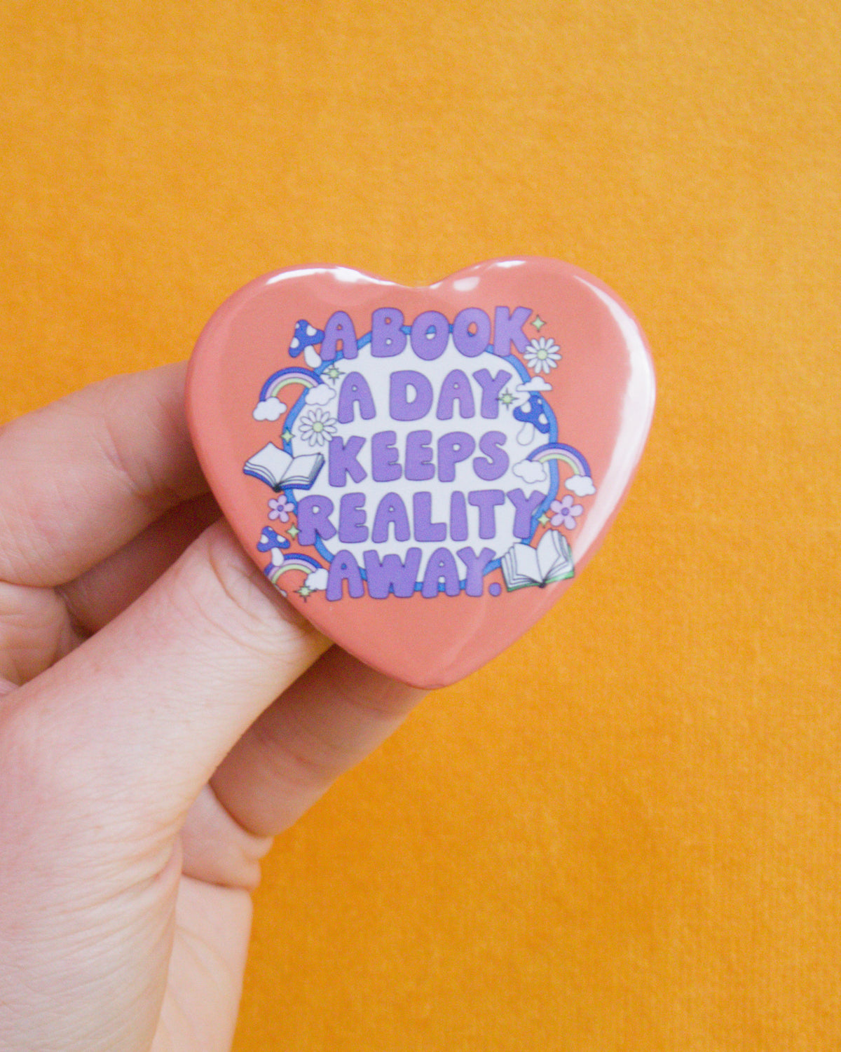 "A book a day keeps reality away" Heart shaped pin